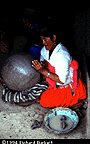 smoothing the surface of a pot with clay mallets