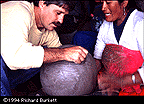 Joe Molinaro tries using the clay mallets on a pot