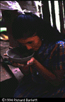 Olivia trims the rim of a mucawa with her teeth